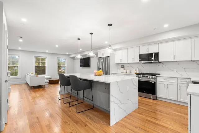 a kitchen with counter top space cabinets and appliances