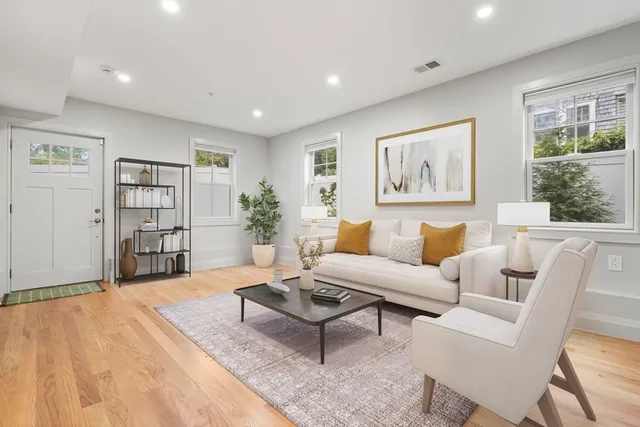 a living room with furniture and a book shelf