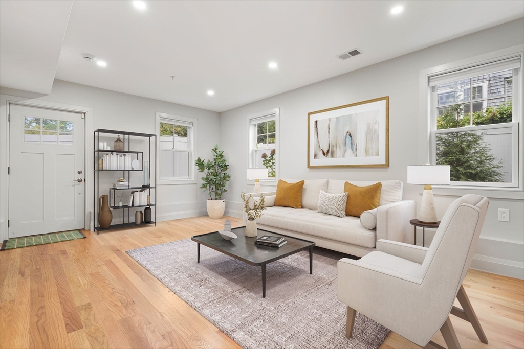 114 Broad Street, Unit D Weymouth, MA 02188 - Photo 25 of 41 a living room with furniture and a book shelf