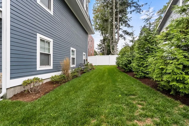 a view of a house with a yard and garden
