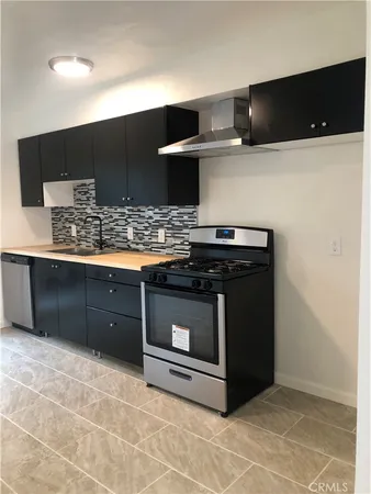 a kitchen with stainless steel appliances a stove and a microwave