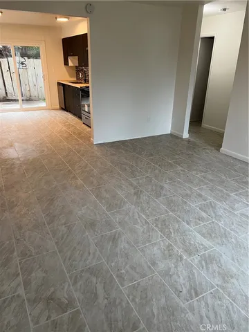 an empty room with cabinet and mirrors