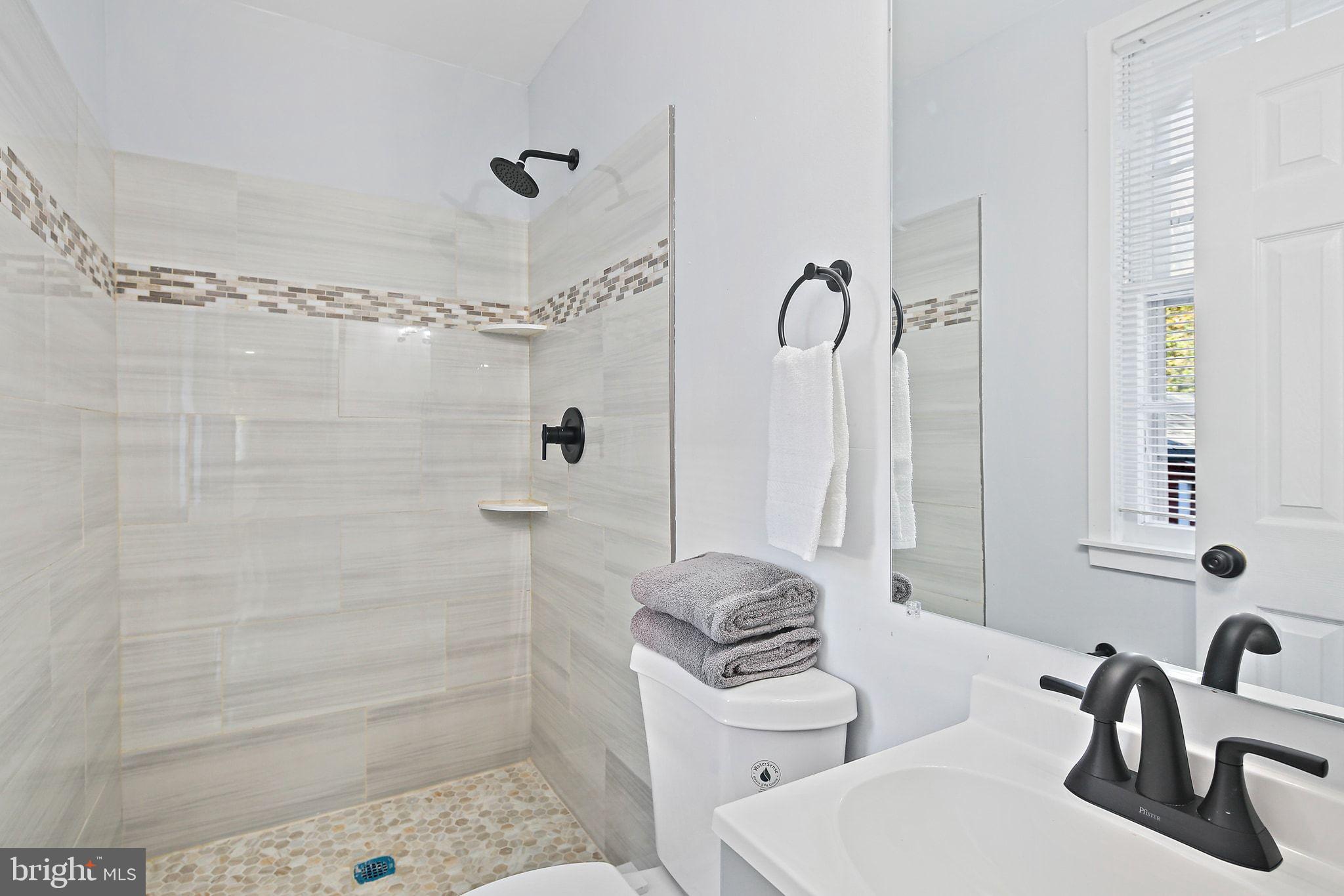 2603 Arcola Avenue Silver Spring, MD 20902 - Photo 13 of 34 a bathroom with a sink toilet and shower