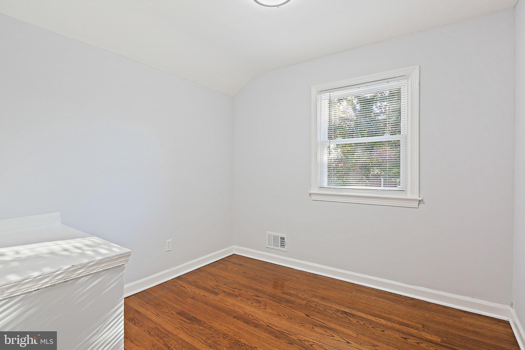 2603 Arcola Avenue Silver Spring, MD 20902 - Photo 18 of 34 wooden floor in an empty room with a window