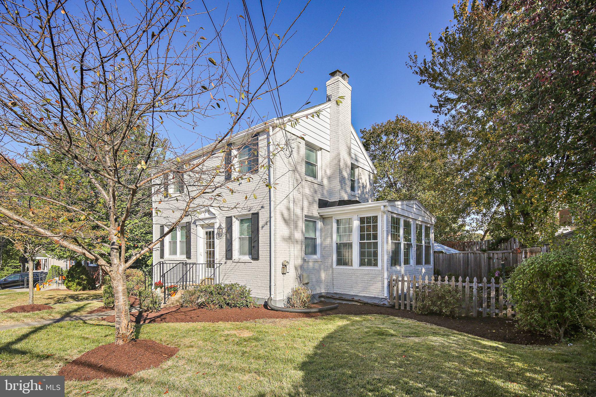 2603 Arcola Avenue Silver Spring, MD 20902 - Photo 2 of 34 a view of a white house next to a yard with large trees
