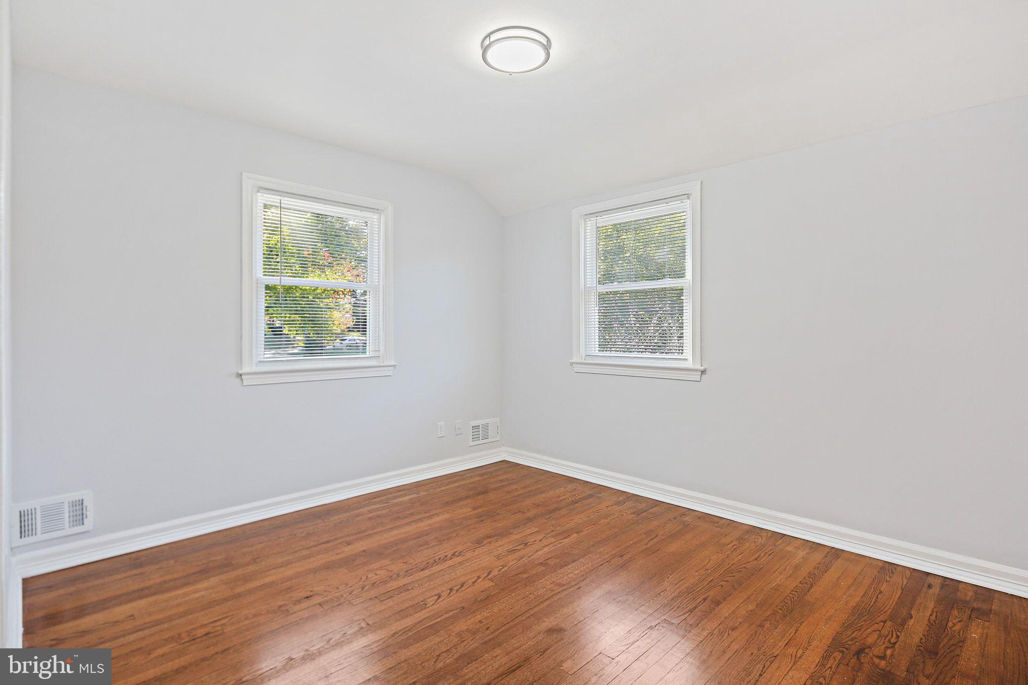 2603 Arcola Avenue Silver Spring, MD 20902 - Photo 23 of 34 an empty room with wooden floor and windows