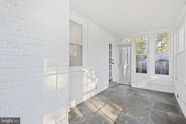 a bathroom with a tub shower and window