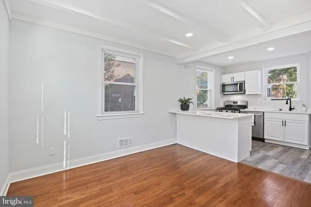 a kitchen with wooden floors and white appliances
