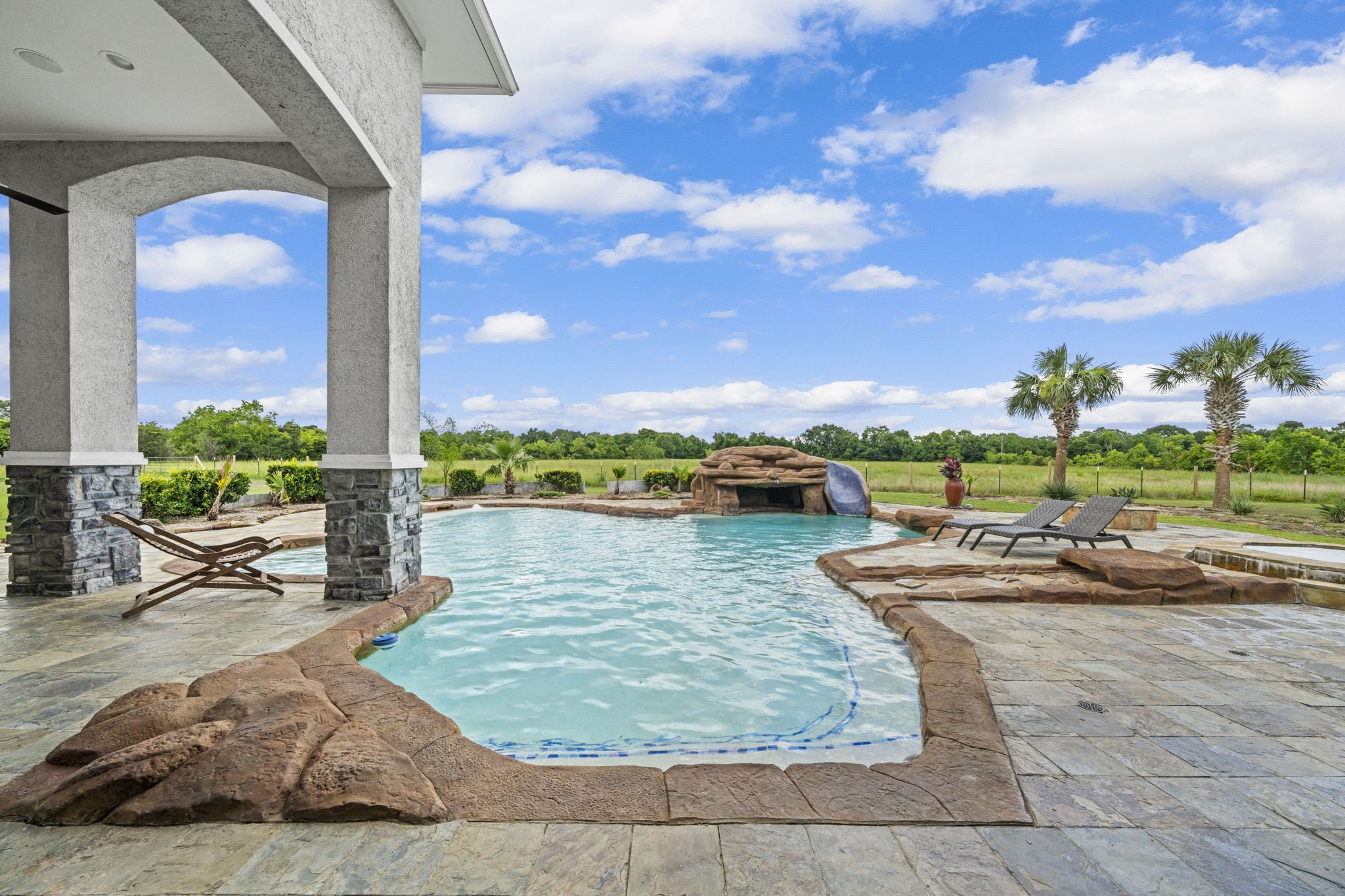 18732 Kz Road Cypress, TX 77433 - Photo 42 of 49 Escape the ordinary in a spectacular backyard retreat, offering a premium saltwater pool and a custom water slide.