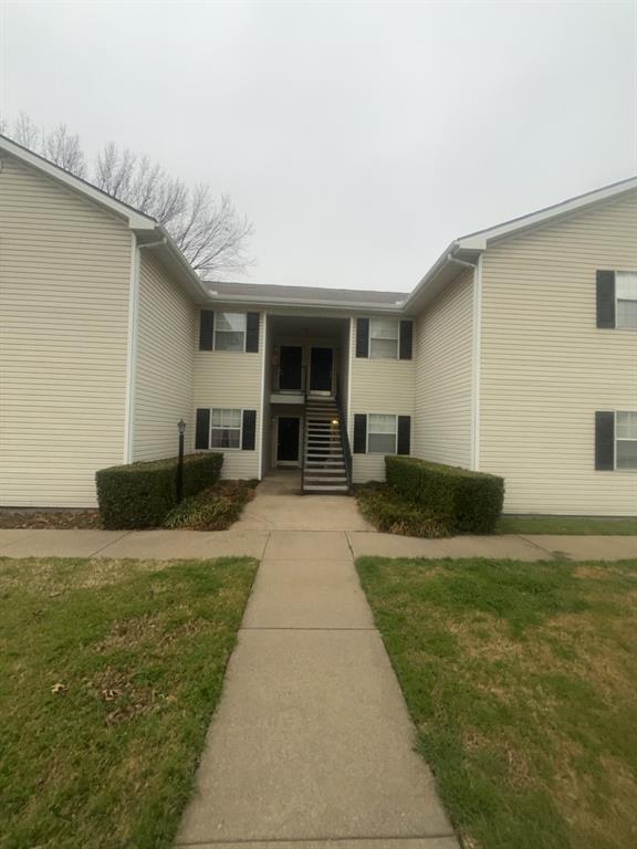 125 Northeast Johnson Avenue, Unit 30 Burleson, TX 76028 - Photo 2 of 13 View of exterior entry with a lawn