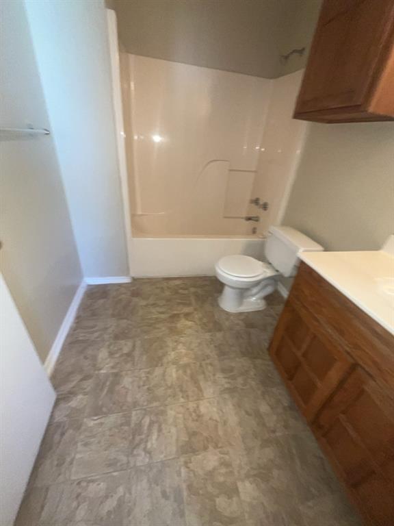 125 Northeast Johnson Avenue, Unit 30 Burleson, TX 76028 - Photo 6 of 13 Bathroom featuring bathtub / shower combination, toilet, and vanity