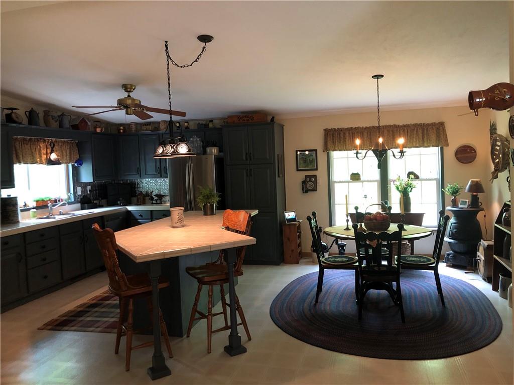 661 Nelson Road Farmington, PA 15437 - Photo 17 of 50 a dining table with chairs and view of kitchen