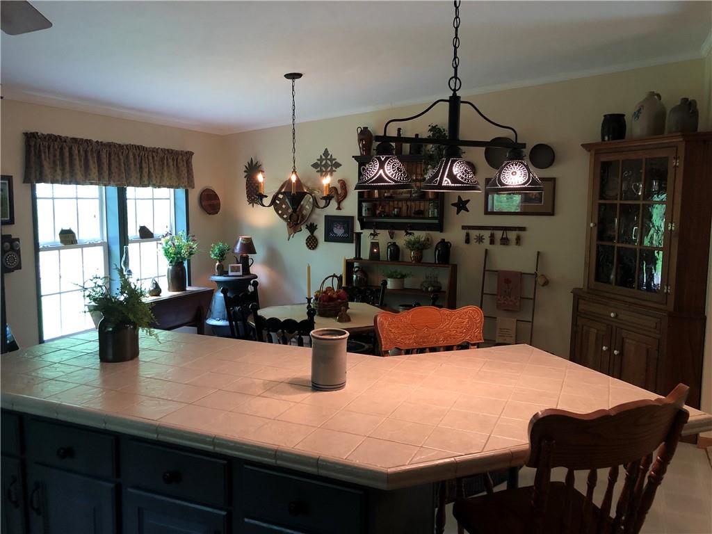 661 Nelson Road Farmington, PA 15437 - Photo 23 of 50 a dining room filled with lots of furniture a chandelier and a window