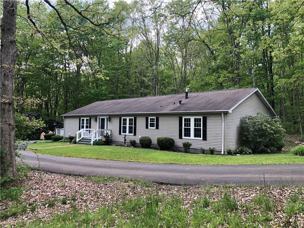 661 Nelson Road Farmington, PA 15437 - Photo 3 of 50 a front view of a house with a garden