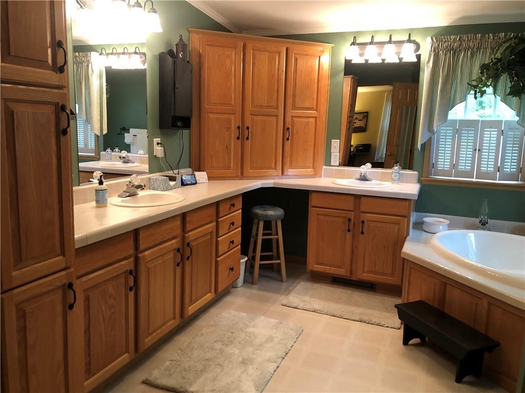661 Nelson Road Farmington, PA 15437 - Photo 32 of 50 a spacious bathroom with a double vanity sink a mirror and a bathtub