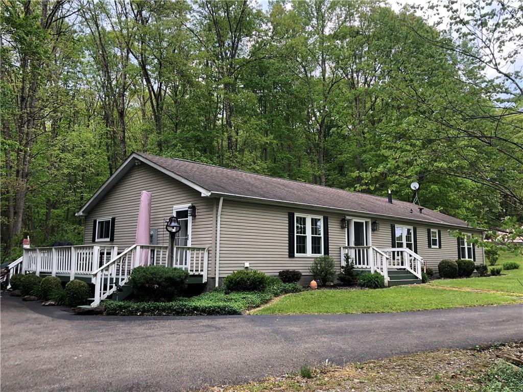 661 Nelson Road Farmington, PA 15437 - Photo 4 of 50 a front view of a house with a yard and outdoor seating