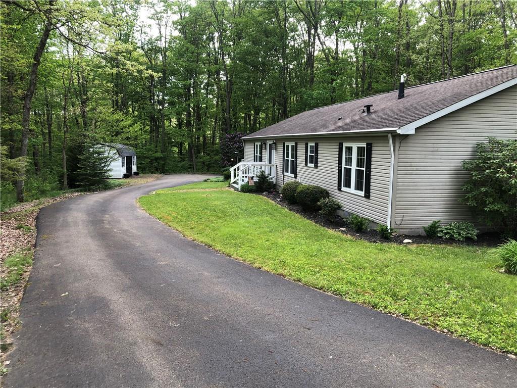661 Nelson Road Farmington, PA 15437 - Photo 41 of 50 a view of a house with a yard plants and large tree