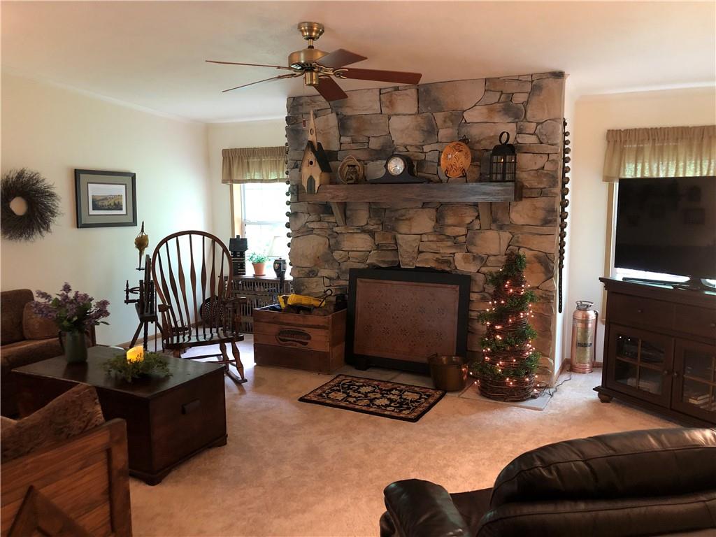 661 Nelson Road Farmington, PA 15437 - Photo 9 of 50 a living room with furniture a flat screen tv and a fireplace