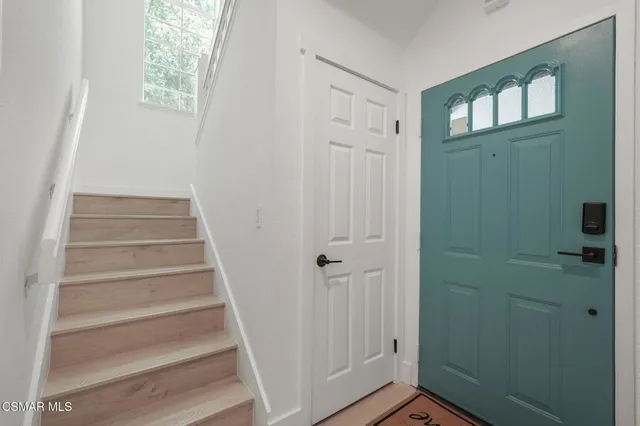 a view of staircase with white walls and a window