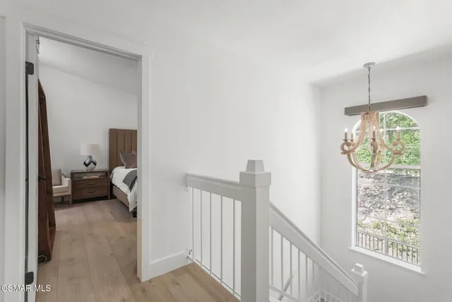 a view of a hallway to a livingroom with furniture