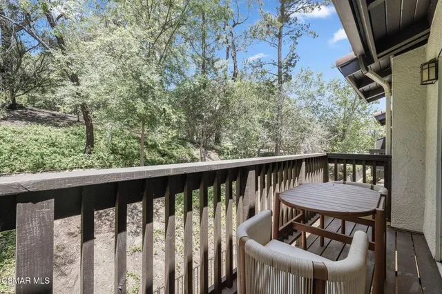 a view of a chair and table in the balcony