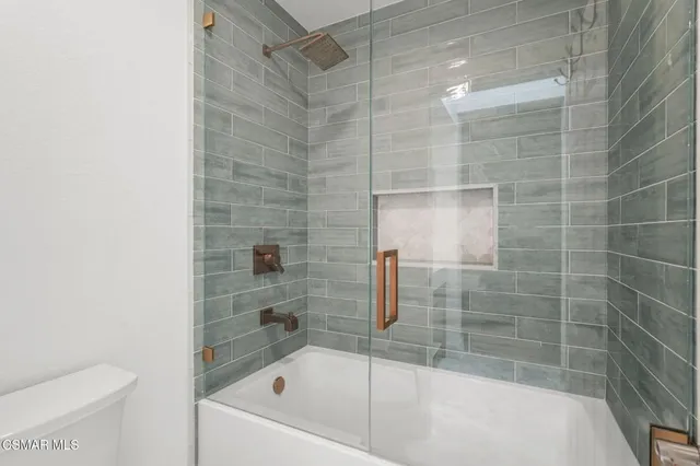 a bathroom with a bathtub and a toilet