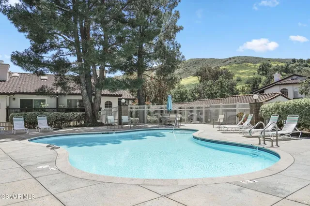 a view of a swimming pool with a patio