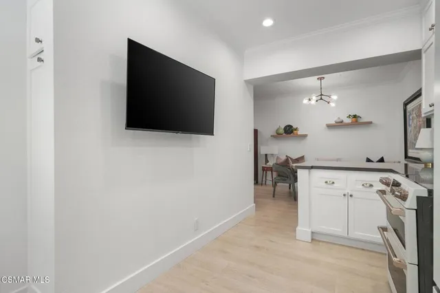 a view of kitchen with a flat screen tv and a fireplace