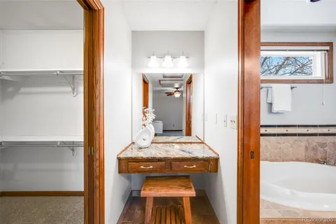 a spacious bathroom with a granite countertop tub sink and mirror