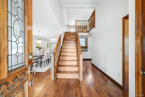 a view of entryway and hall with wooden floor
