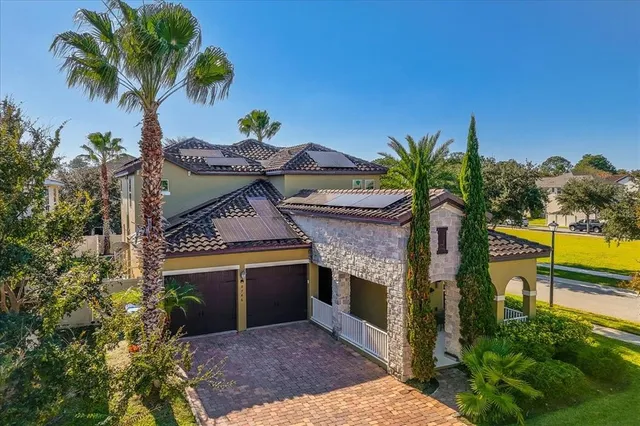 a front view of a house with a yard and swimming pool