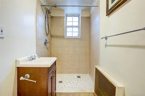 a bathroom with a sink a mirror and shower