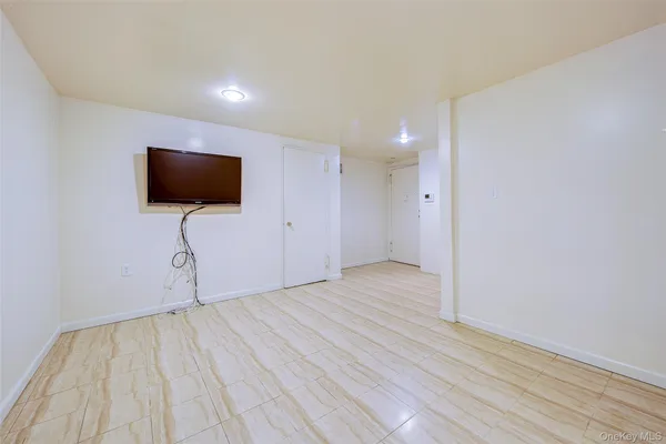 a view of a livingroom with wooden floor and a flat screen tv