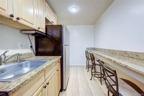 a kitchen with stainless steel appliances granite countertop a sink a stove and a wooden floors