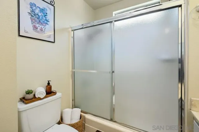 a white toilet sitting next to a bathroom sink