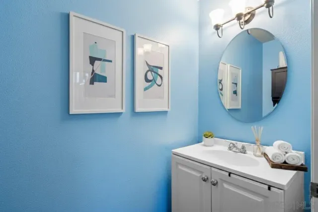 a bathroom with a sink and mirror with toilet