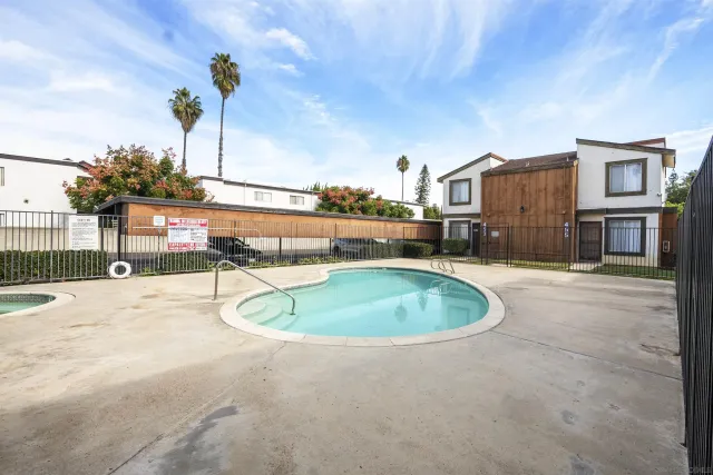 a swimming pool with yard and outdoor seating