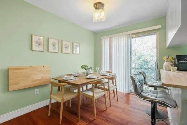a view of a dining room with furniture window and wooden floor