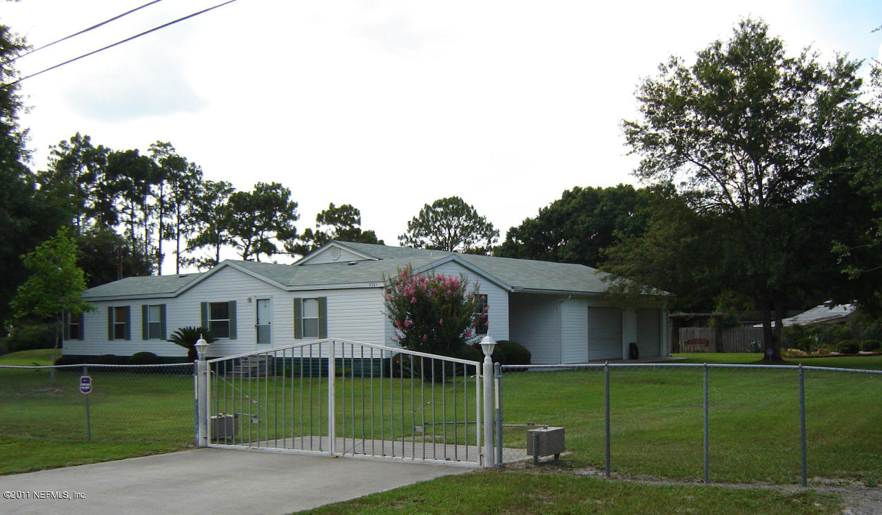 9361 Hipps Road Jacksonville, FL 32222 - Photo 1 of 21 a view of a house with a yard and a garden