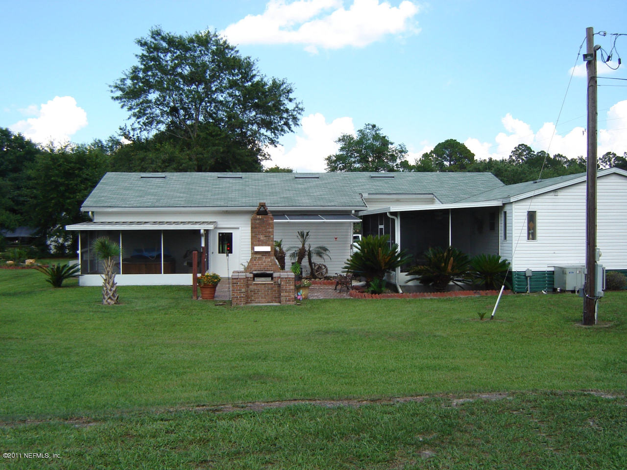 9361 Hipps Road Jacksonville, FL 32222 - Photo 14 of 21 a front view of house with a garden and porch