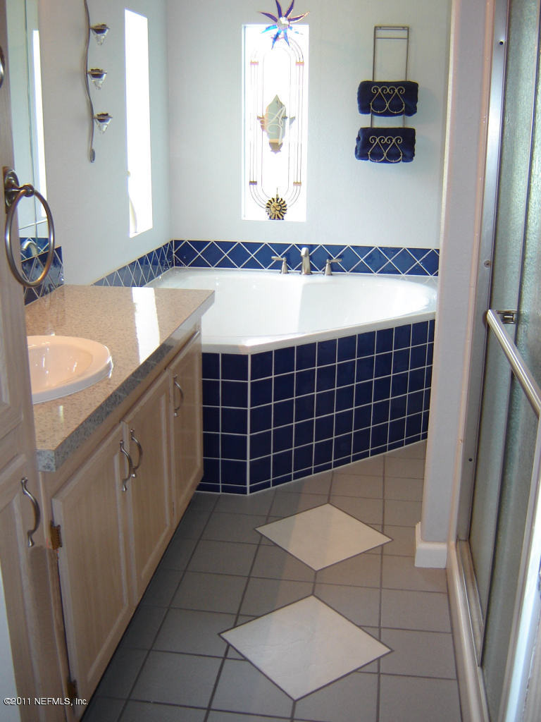 9361 Hipps Road Jacksonville, FL 32222 - Photo 21 of 21 a view of a bathroom with a sink and a mirror