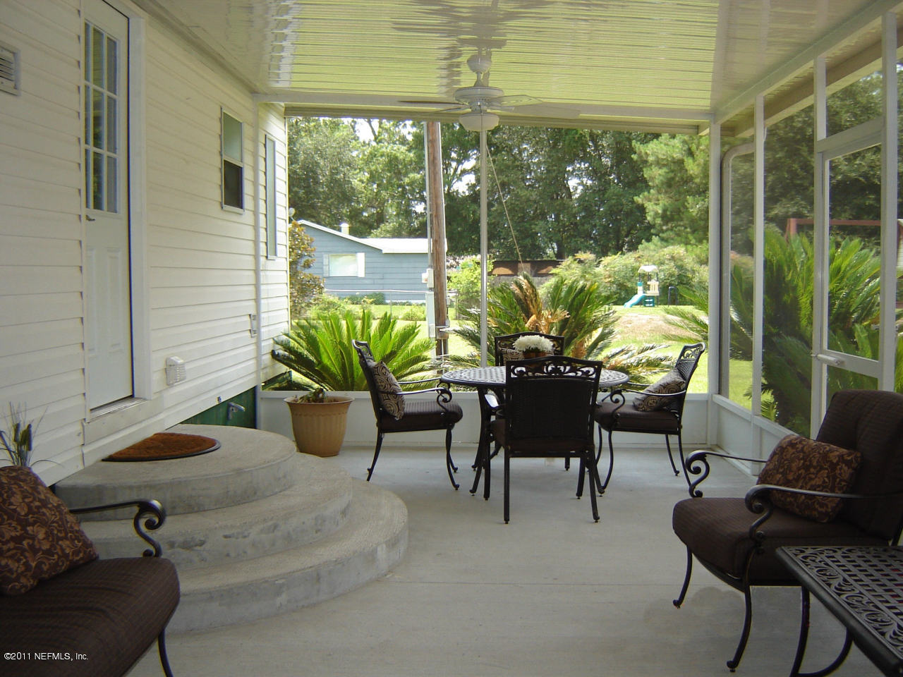 9361 Hipps Road Jacksonville, FL 32222 - Photo 10 of 21 a view of a porch with chairs and potted plants