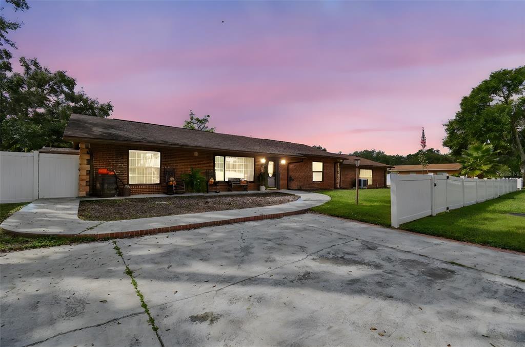 39501 Meadowood Loop Zephyrhills, FL 33542 - Photo 1 of 1 a front view of a house with a yard and garage