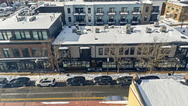 a view of a building with cars parked