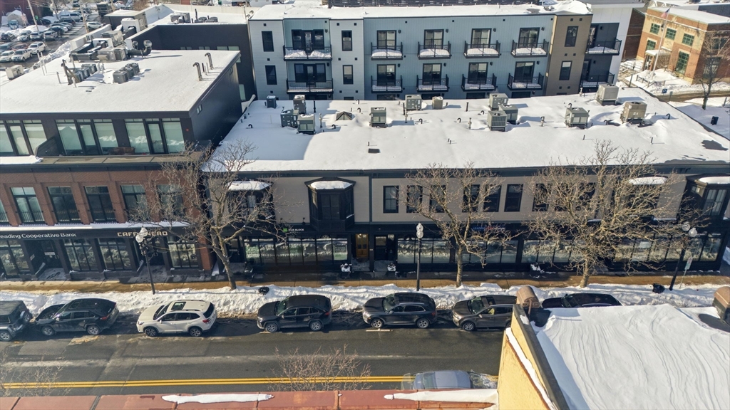 534 Main Street, Unit 11 Melrose, MA 02176 - Photo 11 of 16 a view of a building with cars parked