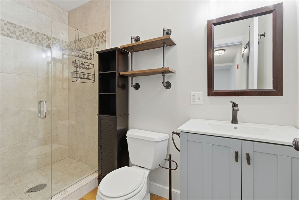 534 Main Street, Unit 11 Melrose, MA 02176 - Photo 6 of 16 a bathroom with a sink a toilet and shower