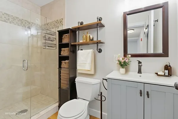a bathroom with a sink a toilet and shower