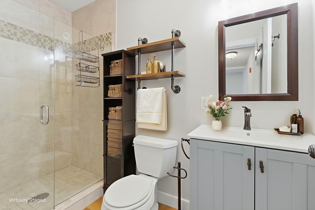 534 Main Street, Unit 11 Melrose, MA 02176 - Photo 7 of 16 a bathroom with a sink a toilet and shower