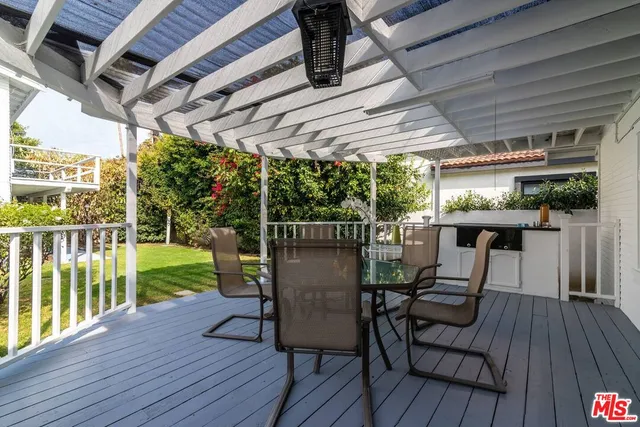 a view of a chairs and table on the wooden deck