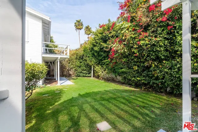 a view of a house with a yard and garden